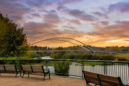 park benches on riverfront at sunset