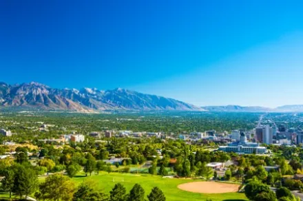aerial view of city on sunny day with mountains in the background