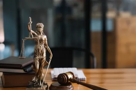 statue of lady justice on desk of judge or lawyer