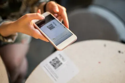 woman scanning QR code with smartphone