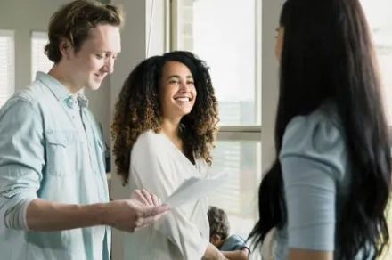 couple discusses paperwork with woman